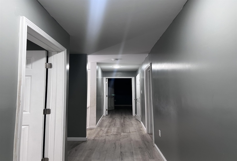 Hall featuring baseboards and light wood-type flooring