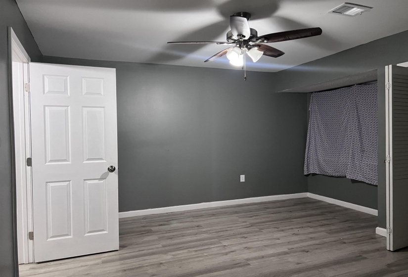 Unfurnished bedroom with light wood-style floors and ceiling fan