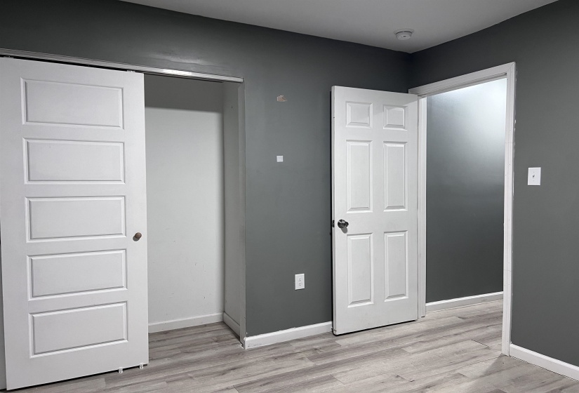 Unfurnished bedroom featuring light wood-type flooring and a closet