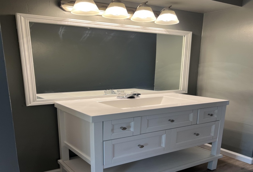 Bathroom with vanity and baseboards