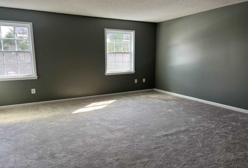 Spare room featuring a textured ceiling and carpet flooring