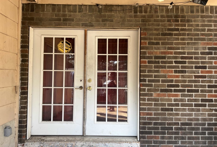 Entrance to property with brick siding