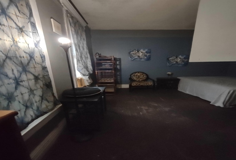 Carpeted bedroom with baseboards