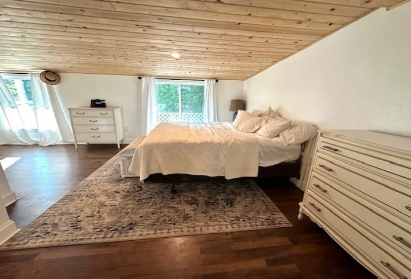Bedroom featuring wooden ceiling, dark hardwood / wood-style floors, and vaulted ceiling