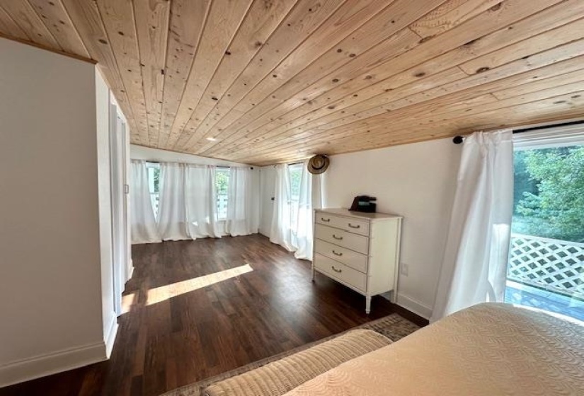 Unfurnished bedroom featuring dark hardwood / wood-style floors and wood ceiling