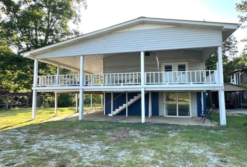 Front of house with a patio, a yard, and a wooden deck