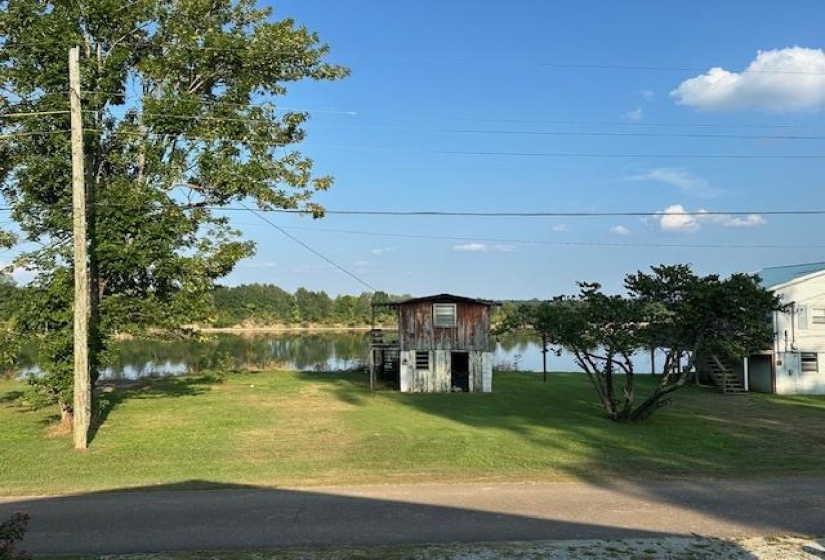 View from front of house featuring a front yard and a water view