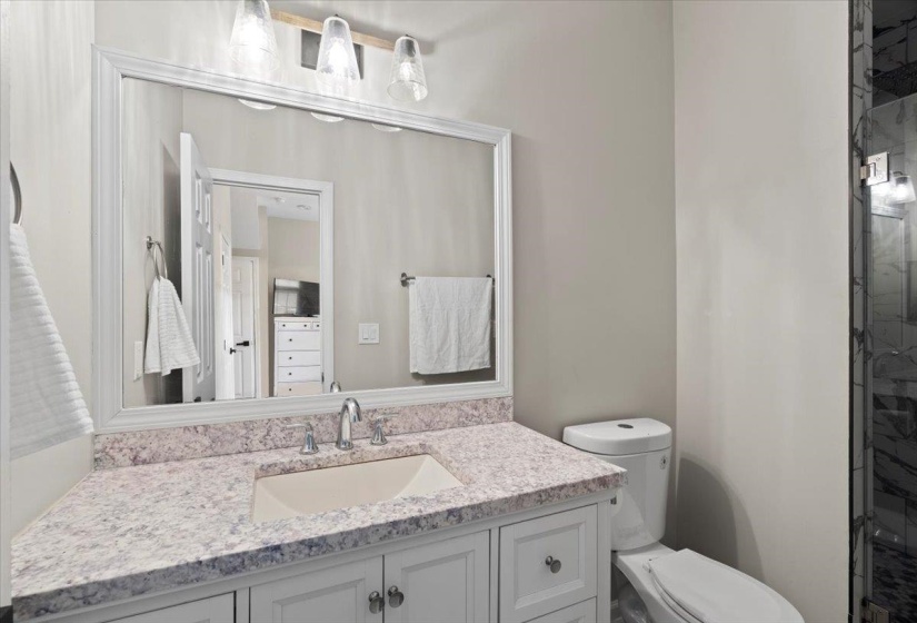 Full bathroom featuring vanity, toilet, and a shower