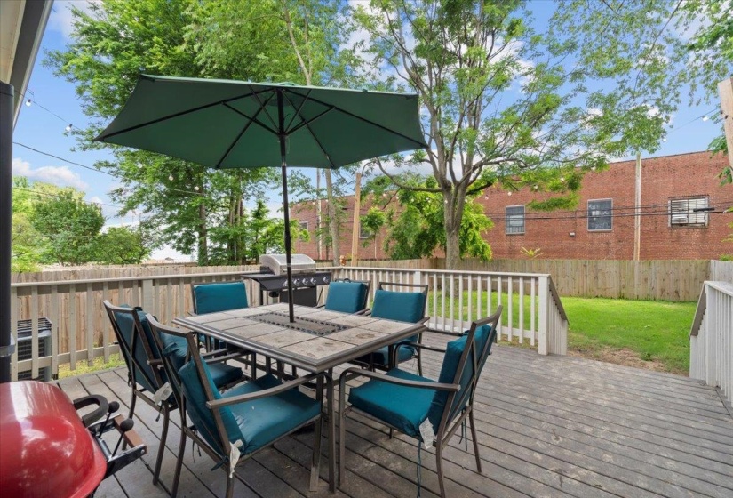 Wooden deck with outdoor dining area and area for grilling