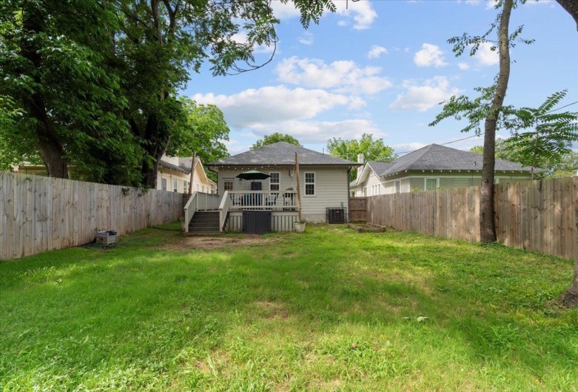 Rear view of property featuring a deck and cooling unit