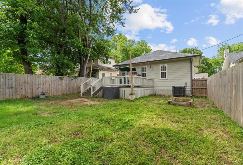 Back of house featuring a wooden deck and central AC unit