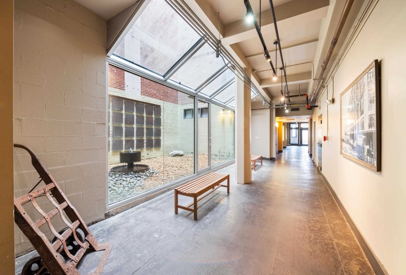This is the first floor lobby across from the elevator.  Features a beautiful courtyard and historic photograph art and period pieces from the historic building.