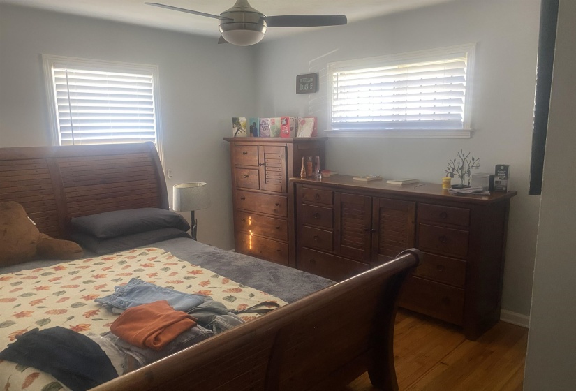 Bedroom with wood finished floors and a ceiling fan