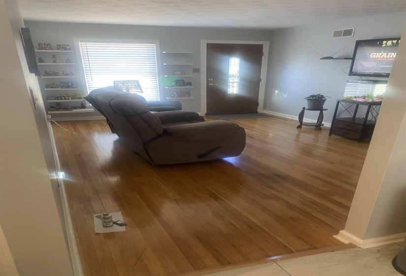 Living area featuring baseboards and light wood-style flooring