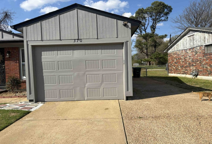 Garage featuring driveway