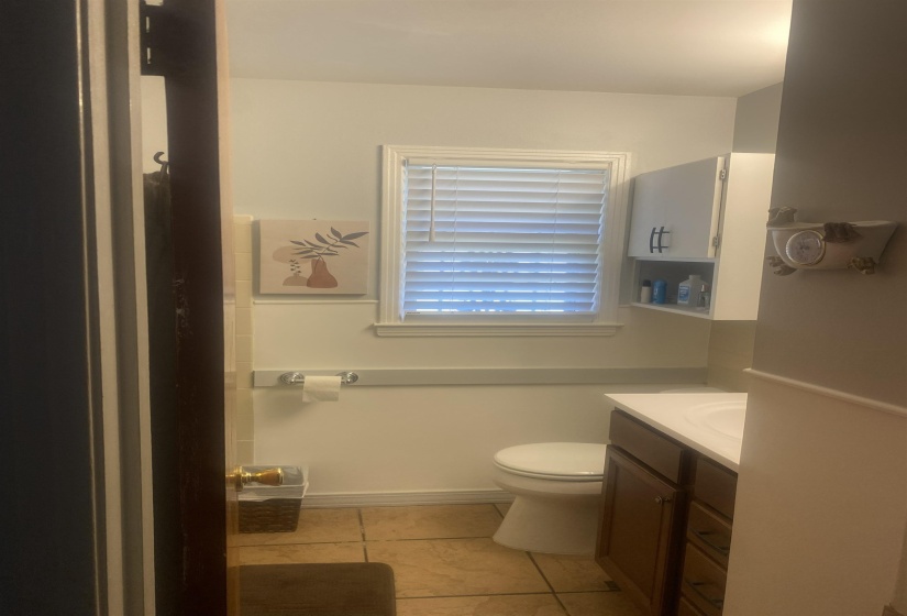 Full bath with vanity and light tile patterned floors