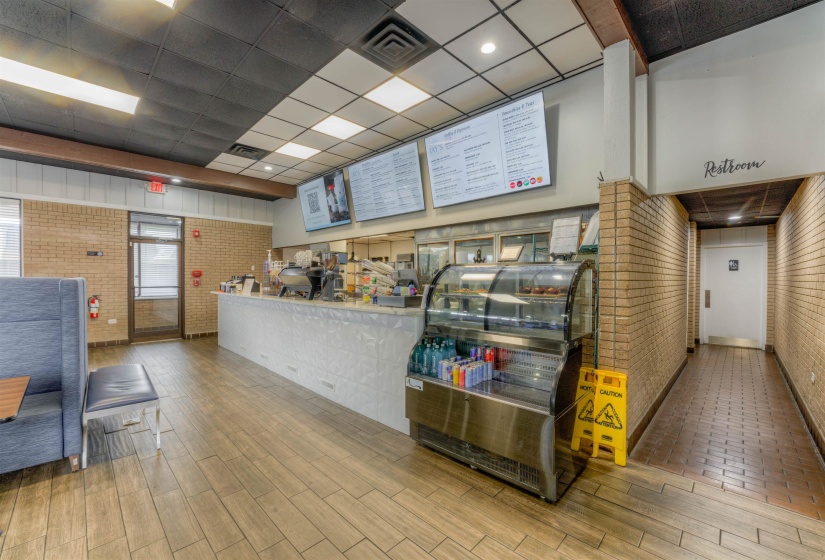 Reception featuring a paneled ceiling and brick wall