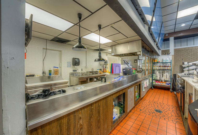 Kitchen with stainless steel countertops and decorative light fixtures