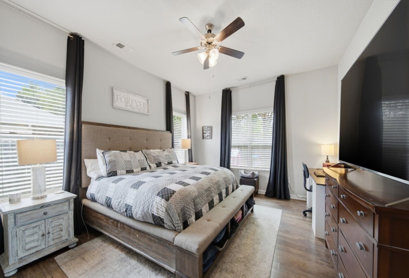 Bedroom with dark wood-type flooring and a ceiling fan