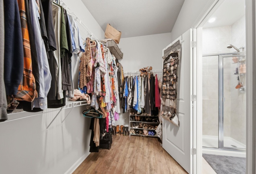 Walk in closet with light wood-style floors