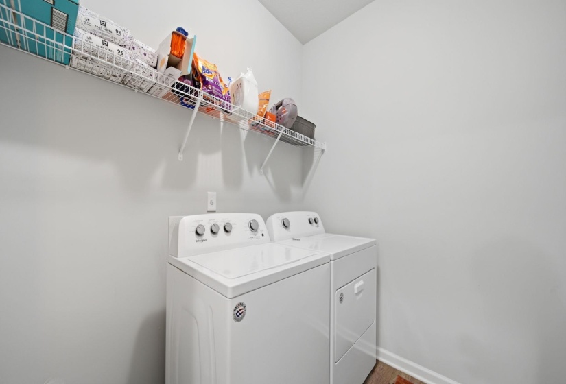 Laundry room with washing machine and dryer and baseboards