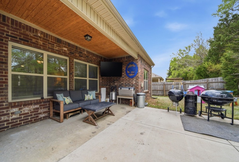 Fenced backyard featuring a patio, an outdoor hangout area, and area for grilling