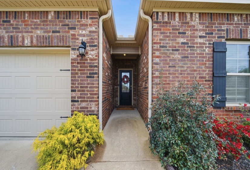 View of exterior entry with brick siding