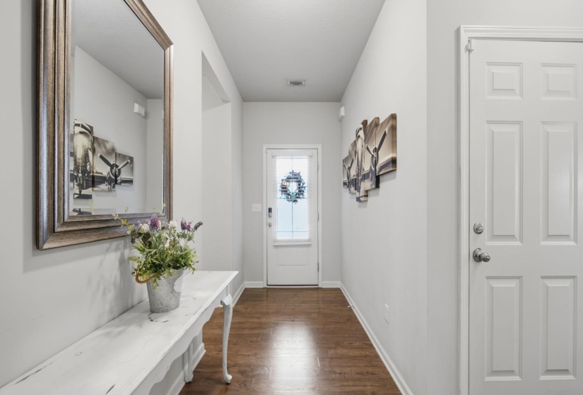 Doorway to outside with wood finished floors and baseboards