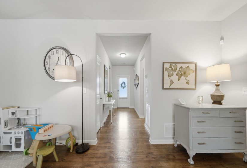 Foyer entrance with dark wood-style flooring and baseboards