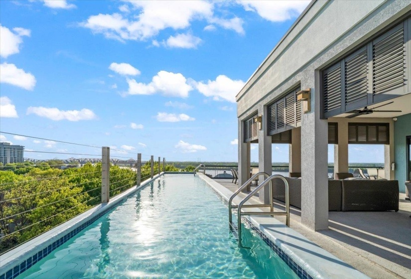 View of pool featuring an infinity pool, patio surround, and outdoor furniture