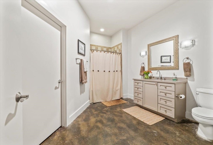 Full bathroom featuring a shower with curtain, vanity, finished concrete floors, and recessed lighting
