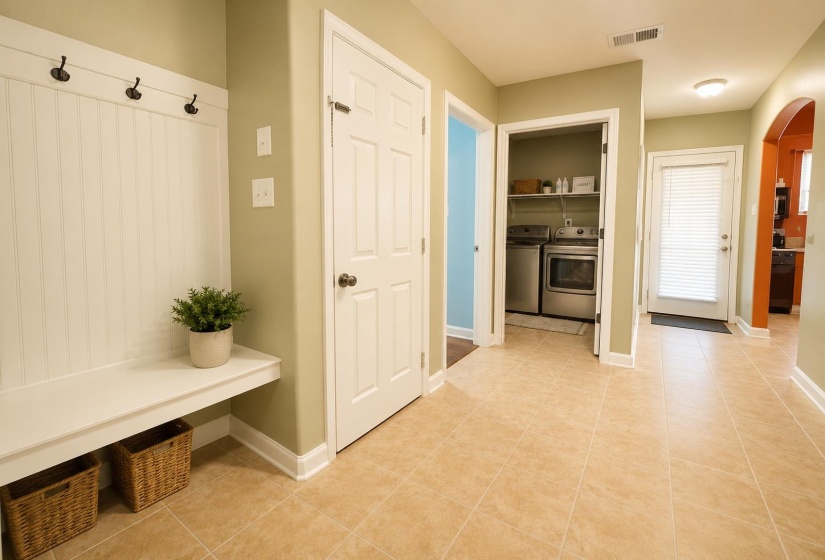 Built-in entryway bench with beadboard backing and coat hooks