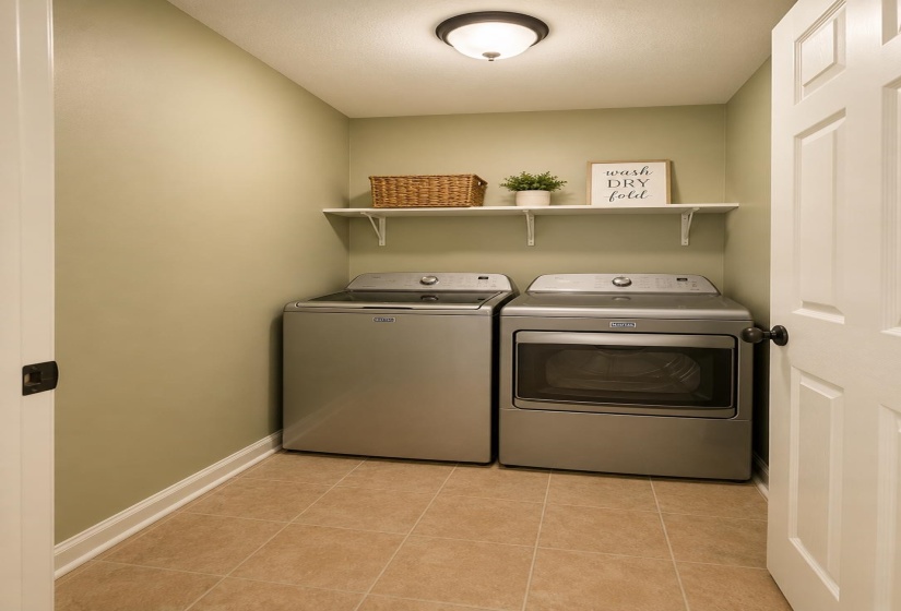 Laundry area featuring neutral wall color, built-in shelving, and tile flooring