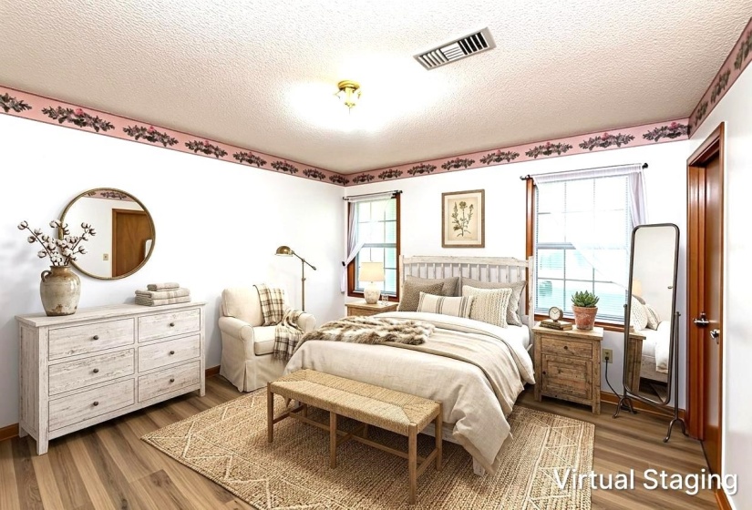 Bedroom featuring wood-finish flooring, two large windows, a ceiling-mounted light fixture, and a decorative wall border