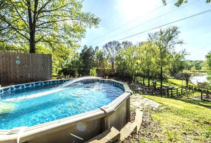 View of swimming pool with a jacuzzi