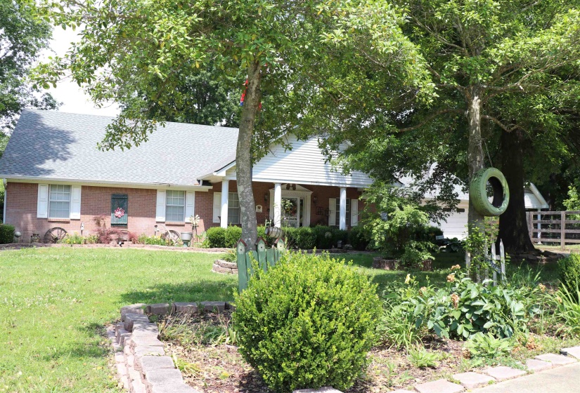 Brick exterior with white shutters and a gabled roofline