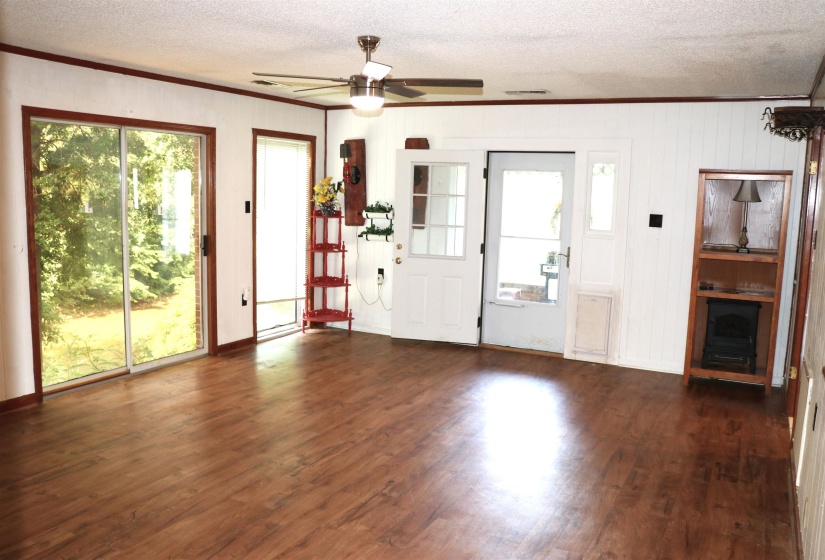 Spacious interior with wood-finish flooring, white paneling, and wood trim details
