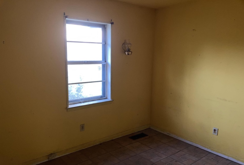 Bedroom featuring baseboards and brick patterned flooring