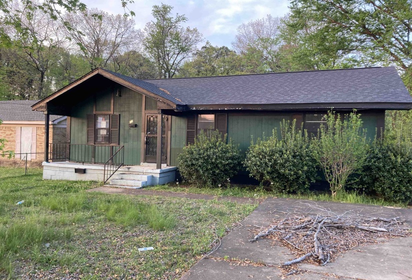 View of front of home with roof with shingles, crawl space, and a porch