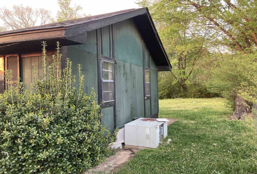View of property exterior with a lawn