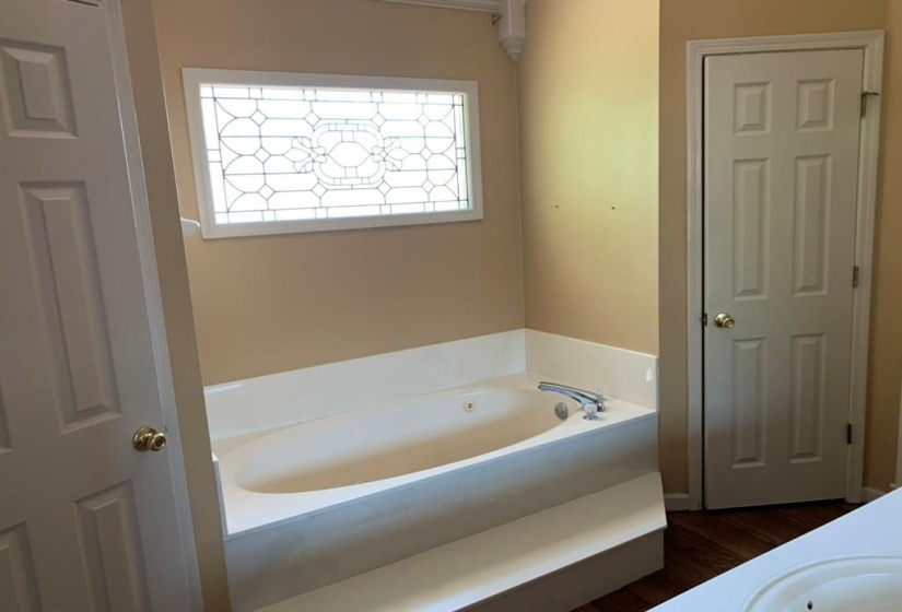 Soaking tub with integrated steps and polished chrome fixtures