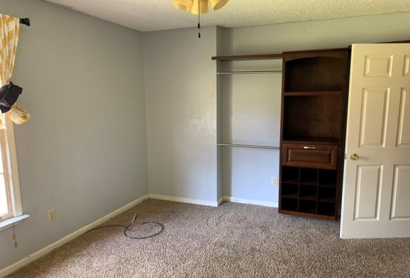 Built-in closet system featuring shelving, hanging rods, and integrated storage