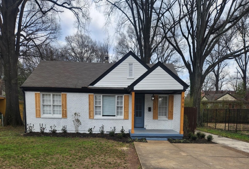 View of front of property featuring covered porch and brick siding