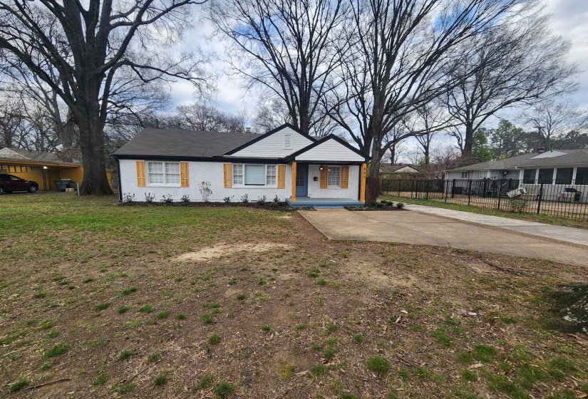 View of front facade with covered porch and concrete driveway