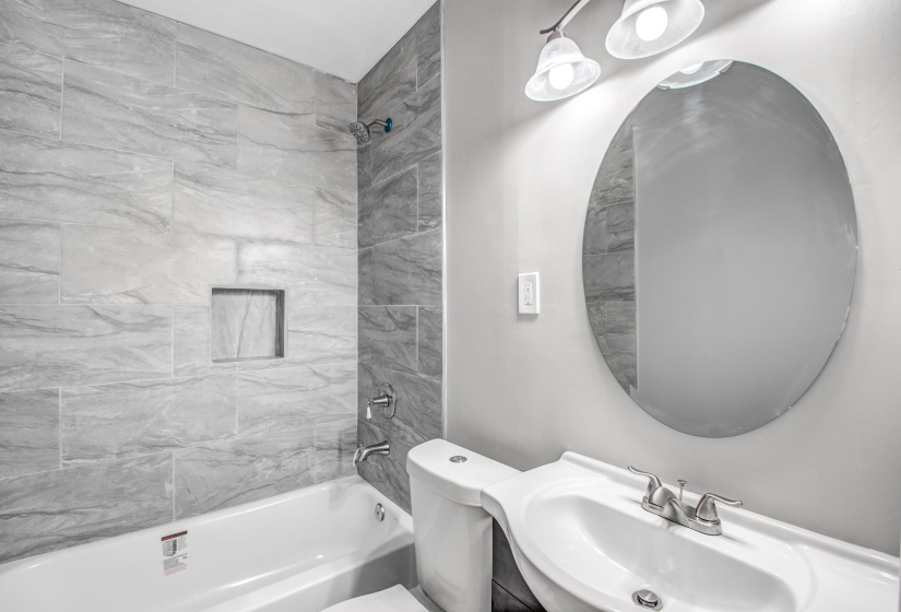Bathroom featuring vanity and shower / tub combination