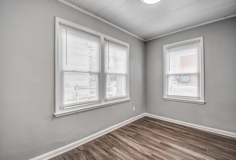 Spare room with dark wood-style floors and ornamental molding