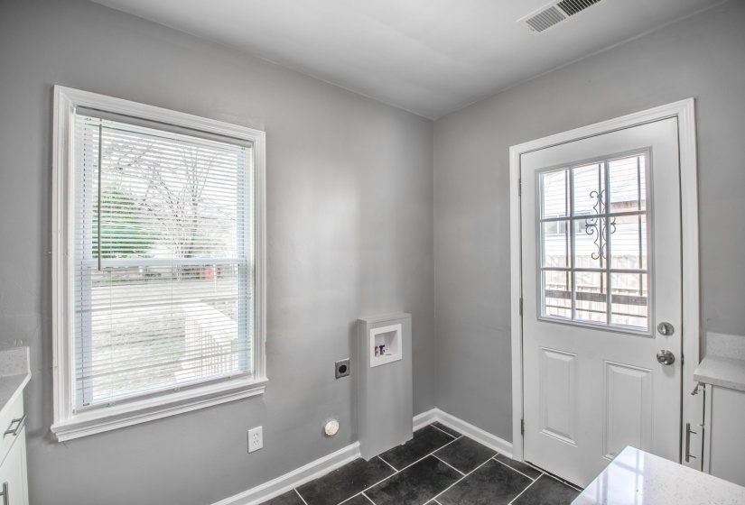 Doorway with tile patterned flooring and healthy amount of natural light