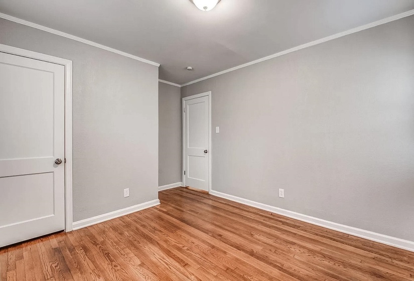 Unfurnished bedroom featuring ornamental molding and light wood-type flooring