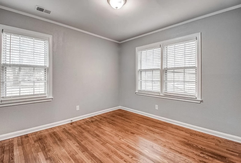 Unfurnished room featuring ornamental molding and light wood finished floors