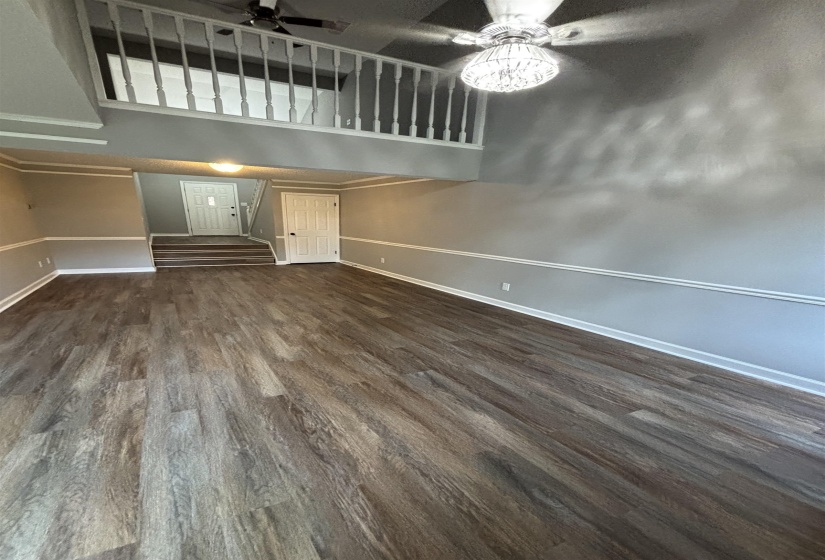 Unfurnished living room with dark wood finished floors and ceiling fan